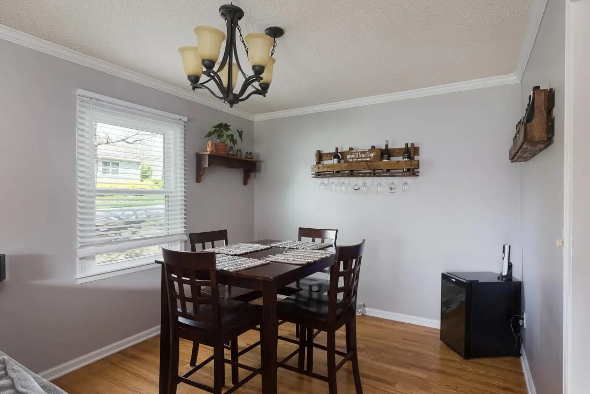 Dining room with hardwood floors and wrought-iron chandelier, Kansas City listing