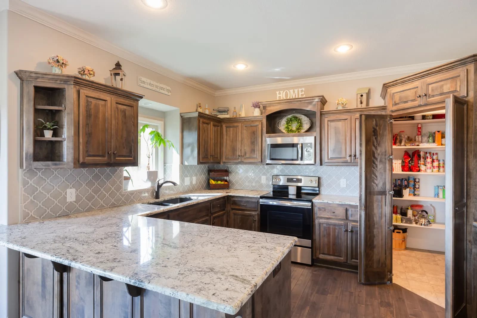 White kitchen with a wood-top island and stainless appliances, Kansas City listing