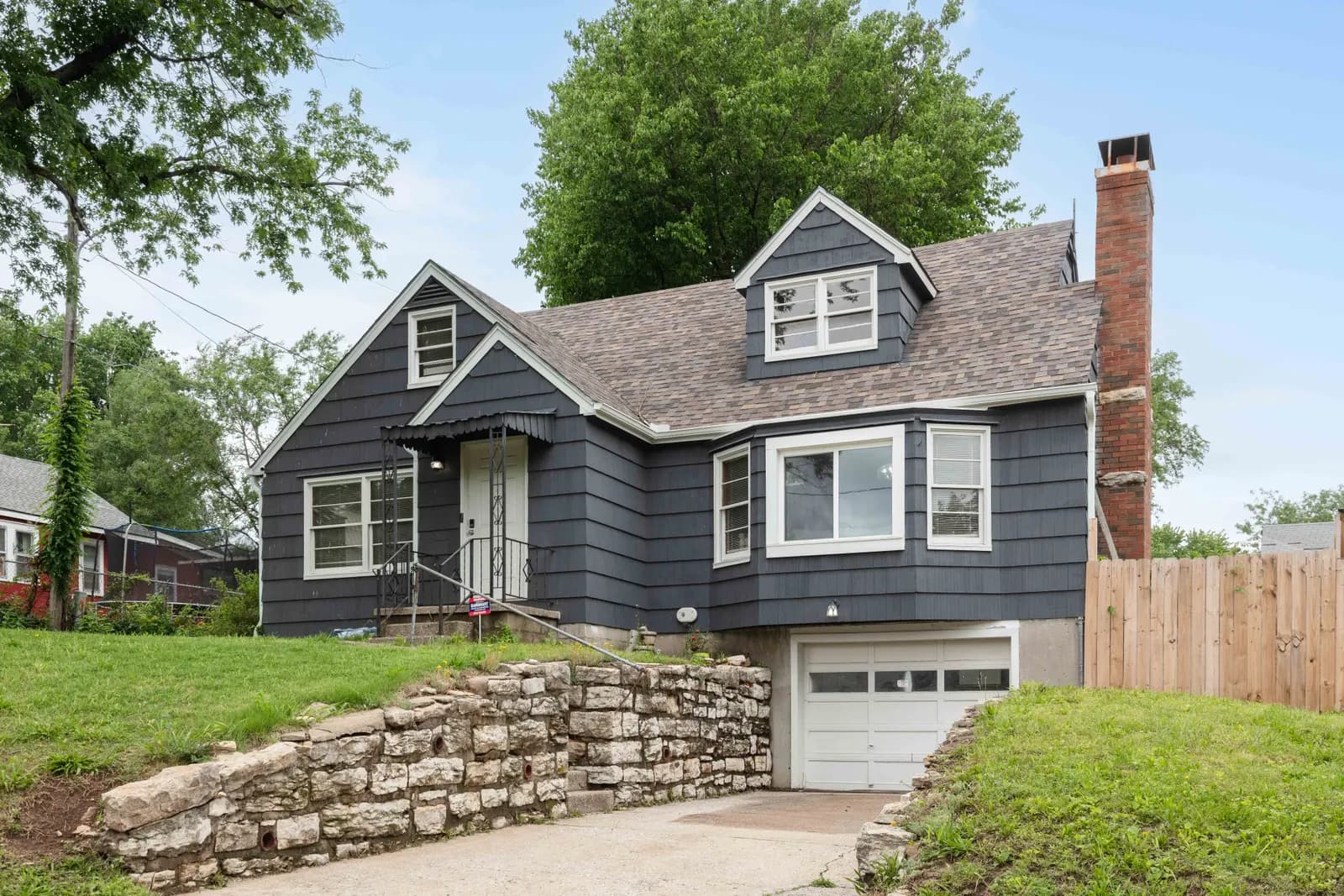 Stone and siding home with a covered porch, Kansas City metro listing