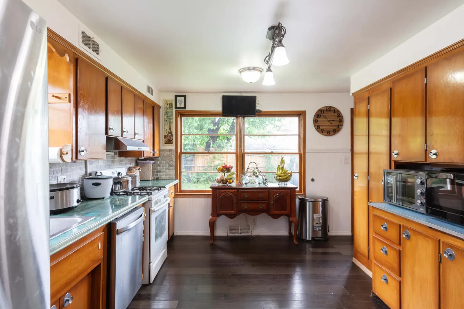 White kitchen with a dark island and wood floors, Kansas City listing