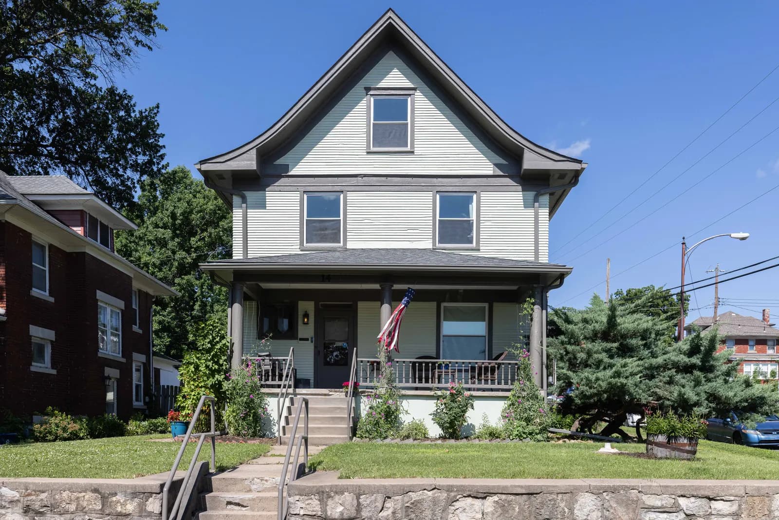 White bungalow with a covered front porch, Kansas City metro listing