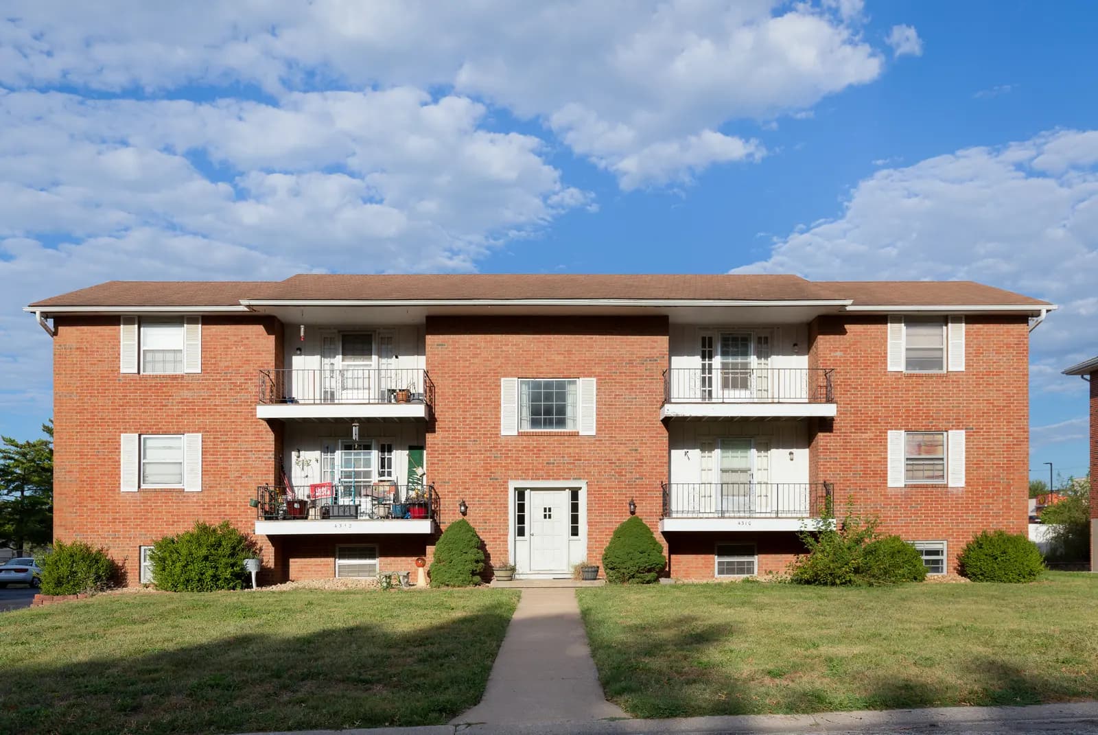 Brick home with a columned front porch, Kansas City metro listing
