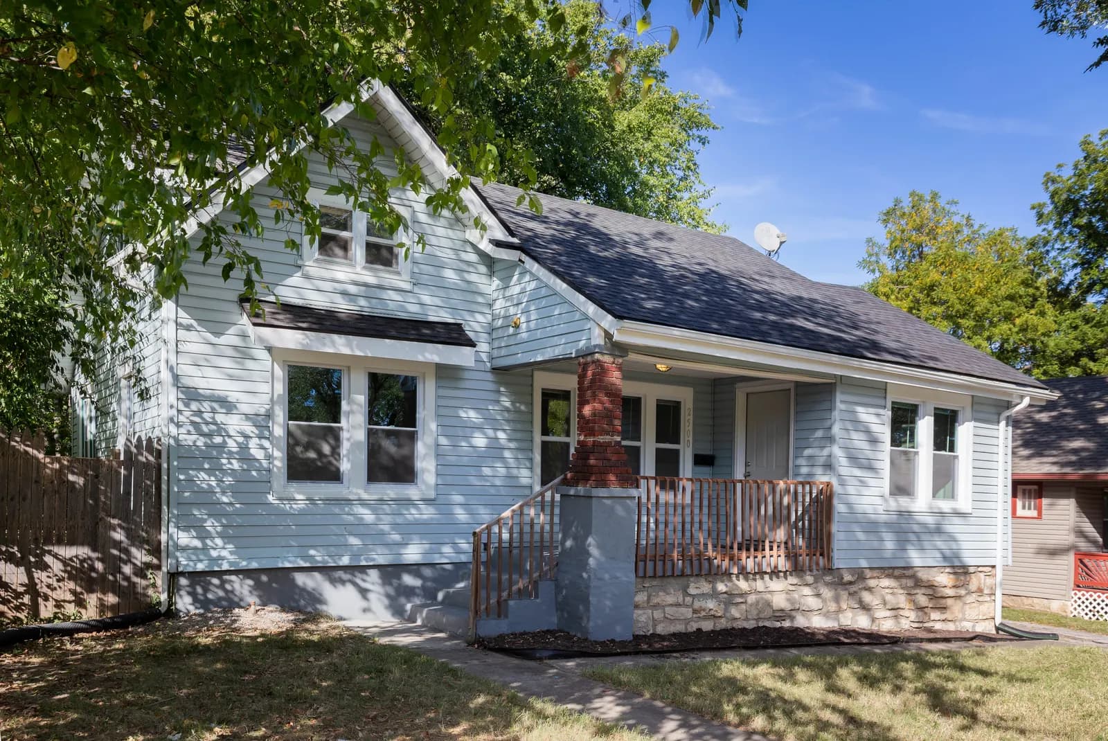 Craftsman brick home with a wide front porch, Kansas City metro listing